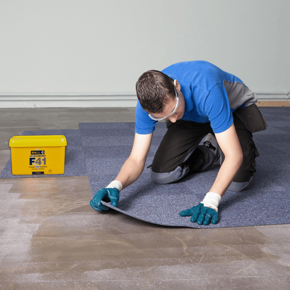 Carpet tiles being laid over Styccobond F41 tackifier