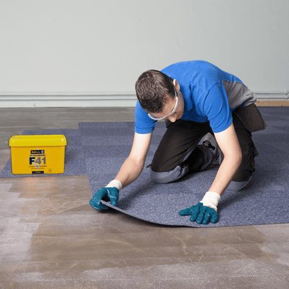Carpet tiles being laid over Styccobond F41 tackifier