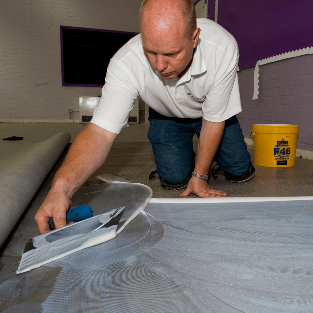 Styccobond F46 pressure sensitive adhesive being trowelled onto a subfloor