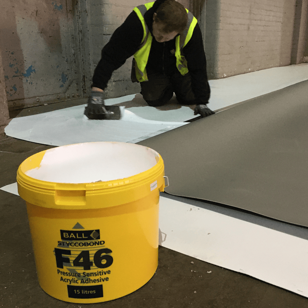Sheet vinyl being laid over Styccobond F46 adhesive