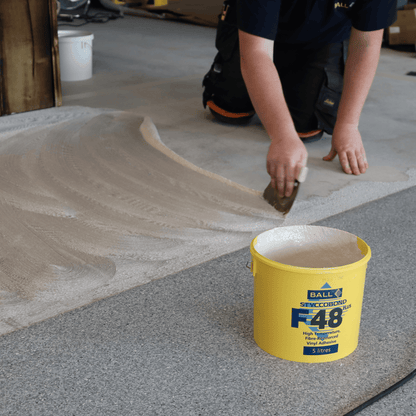 Styccobond F48 Plus being trowelled onto a subfloor