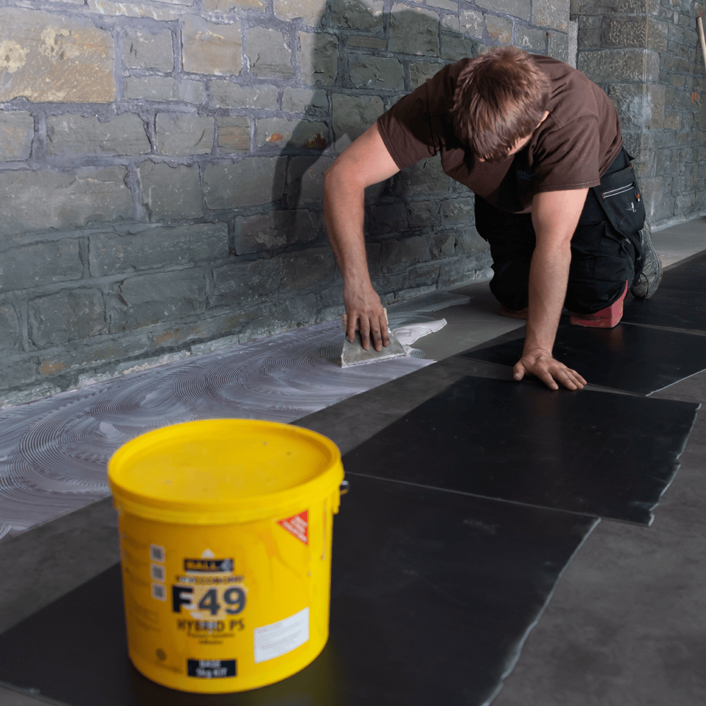Rubber tiles being fitted with Styccobond F49 Hybrid PS adhesive