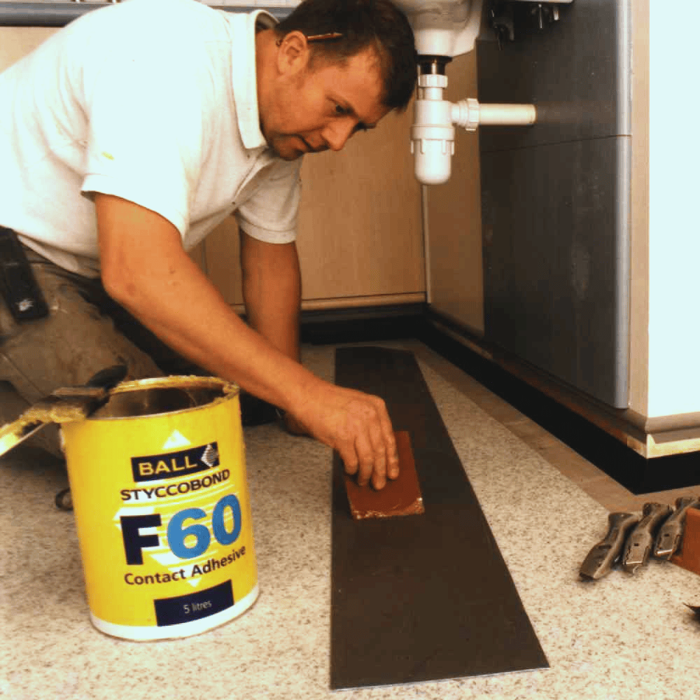 Styccobond F60 contact adhesive being used to fit a rubber nosing