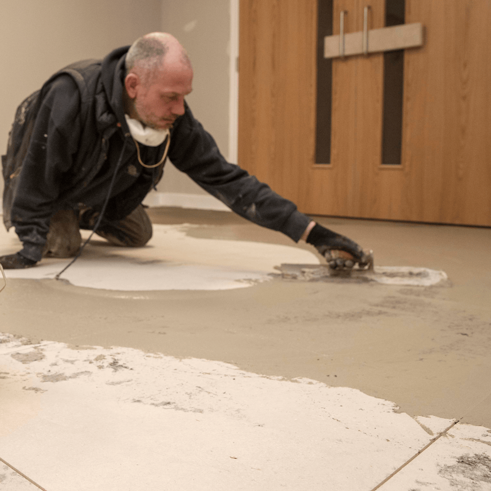 F-Ball Stopgap Fill and Prime being trowelled over floor panels