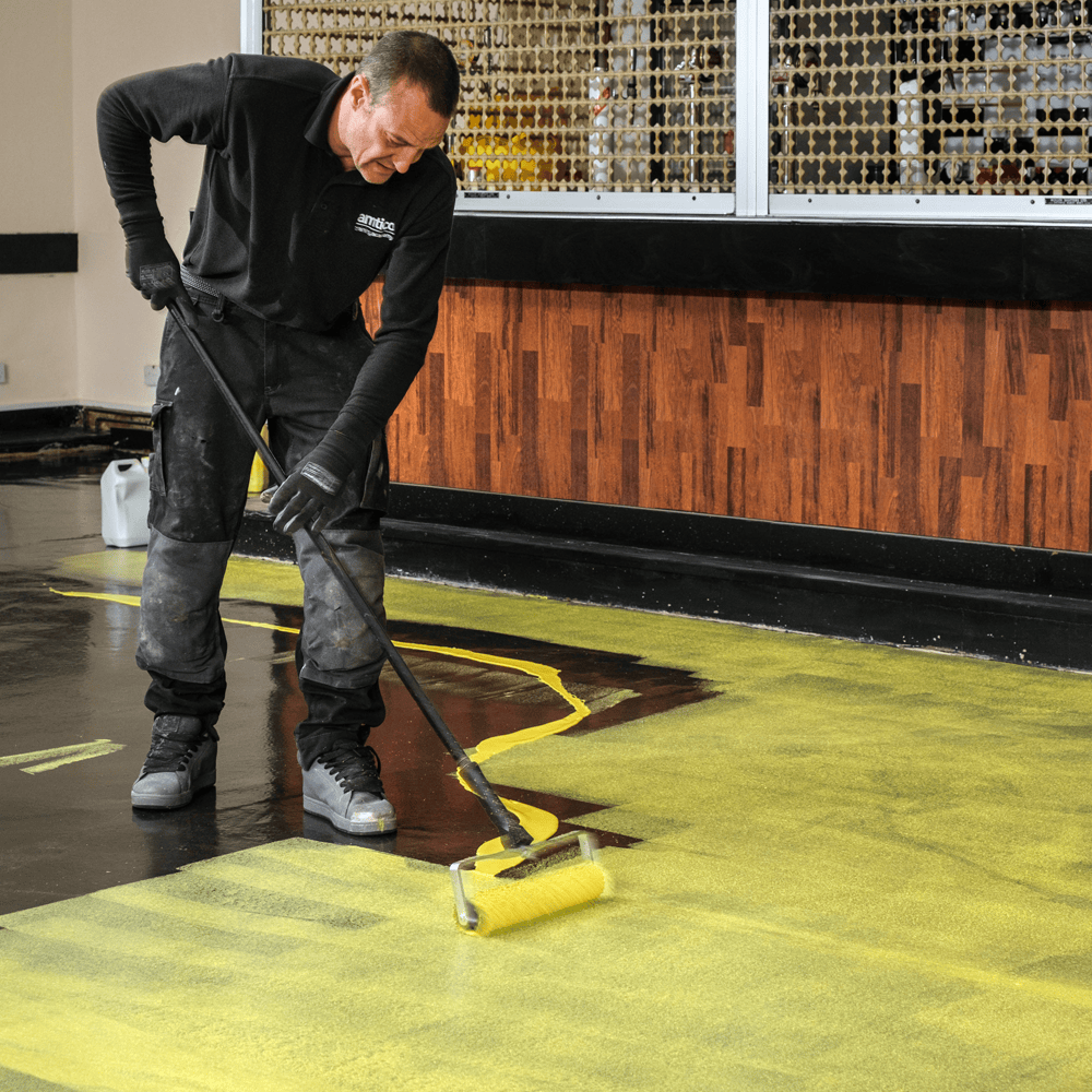 F-Ball Stopgap P141 yellow floor primer being rollered onto a subfloor
