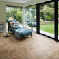 Polyflor Camaro PUR Cambridge Parquet LVT flooring installed in modern living room with natural wood effect